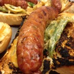Close up view of a Haute Sausage bayou gator sausage with cajun spices and veggies.