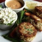 Plate of crab cakes with sauces on the side
